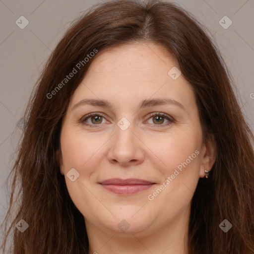 Joyful white adult female with long  brown hair and brown eyes