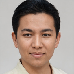 Joyful asian young-adult male with short  black hair and brown eyes