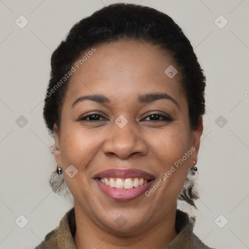 Joyful black adult female with short  brown hair and brown eyes