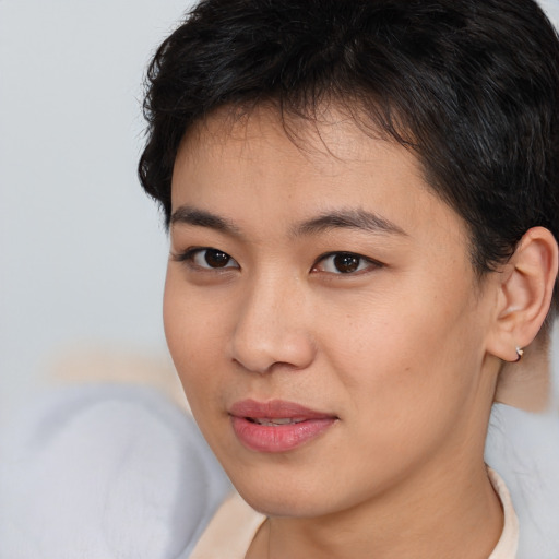 Joyful asian young-adult female with short  brown hair and brown eyes