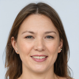 Joyful white adult female with long  brown hair and brown eyes