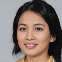 Joyful asian young-adult female with medium  brown hair and brown eyes