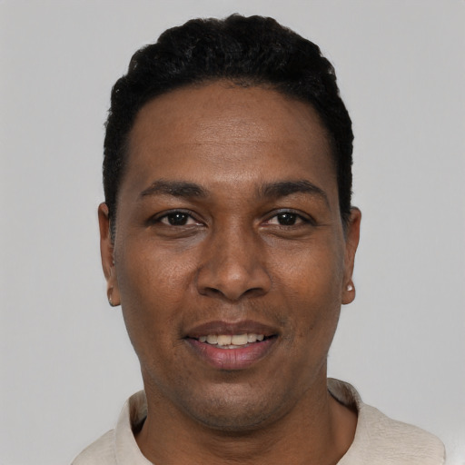 Joyful black young-adult male with short  black hair and brown eyes