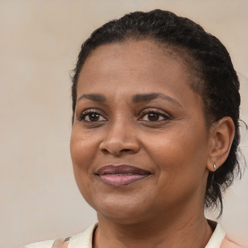 Joyful black adult female with short  brown hair and brown eyes