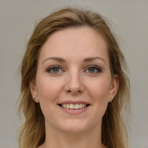 Joyful white young-adult female with long  brown hair and grey eyes