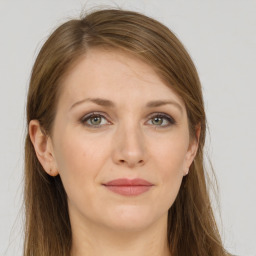 Joyful white young-adult female with long  brown hair and grey eyes