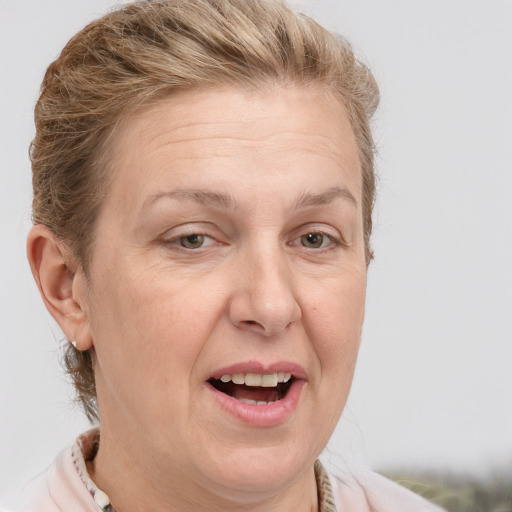 Joyful white adult female with medium  brown hair and grey eyes