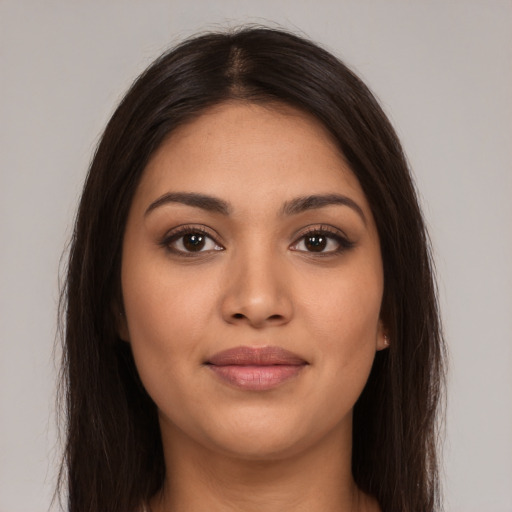 Joyful latino young-adult female with long  brown hair and brown eyes