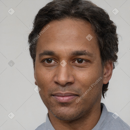 Joyful latino adult male with short  brown hair and brown eyes