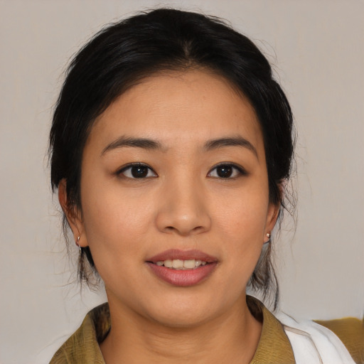 Joyful asian young-adult female with medium  brown hair and brown eyes