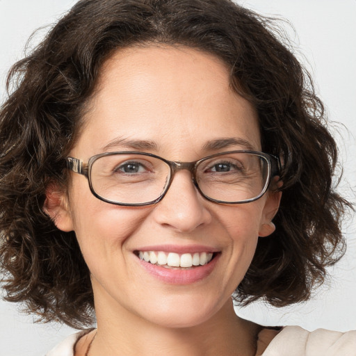 Joyful white adult female with medium  brown hair and blue eyes