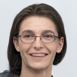 Joyful white adult female with medium  brown hair and grey eyes