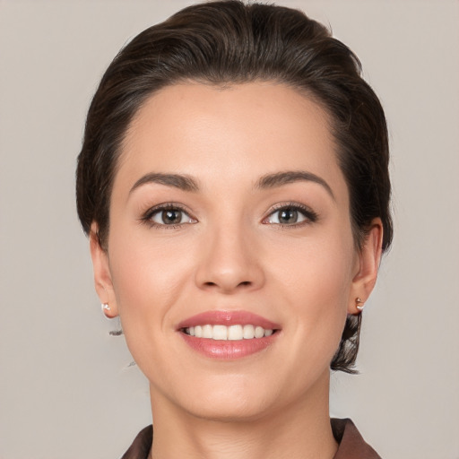 Joyful white young-adult female with medium  brown hair and brown eyes