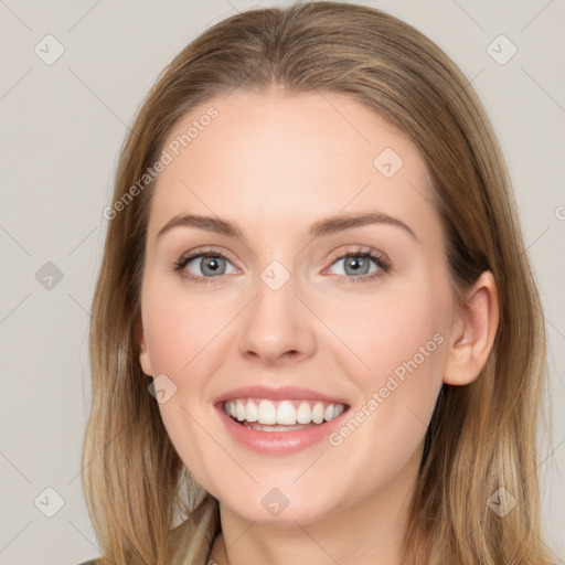 Joyful white young-adult female with long  brown hair and blue eyes