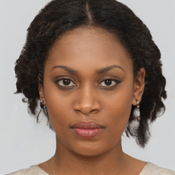 Joyful black young-adult female with medium  brown hair and brown eyes