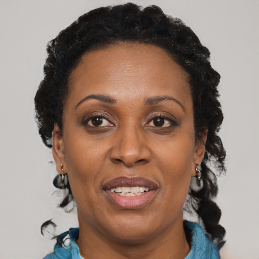 Joyful black adult female with short  brown hair and brown eyes