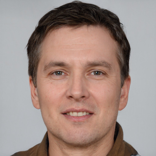 Joyful white adult male with short  brown hair and brown eyes