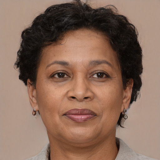 Joyful black adult female with short  brown hair and brown eyes