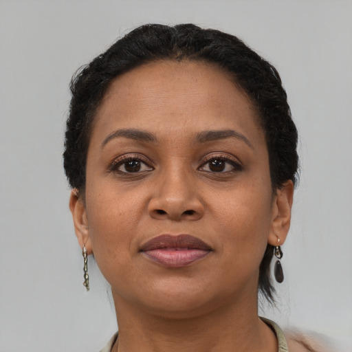 Joyful latino adult female with short  brown hair and brown eyes