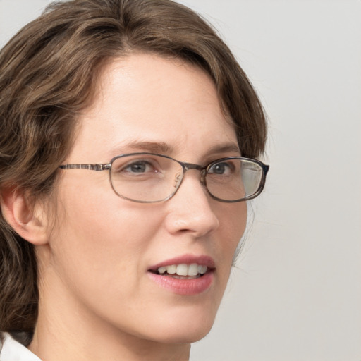 Joyful white young-adult female with medium  brown hair and blue eyes