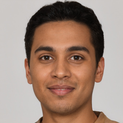 Joyful latino young-adult male with short  black hair and brown eyes