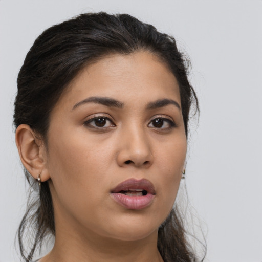 Joyful latino young-adult female with long  brown hair and brown eyes