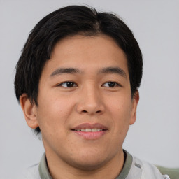 Joyful asian young-adult male with short  brown hair and brown eyes