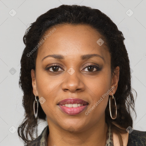 Joyful black young-adult female with long  brown hair and brown eyes