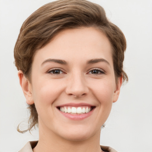 Joyful white young-adult female with short  brown hair and grey eyes