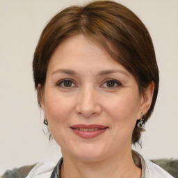 Joyful white adult female with medium  brown hair and brown eyes