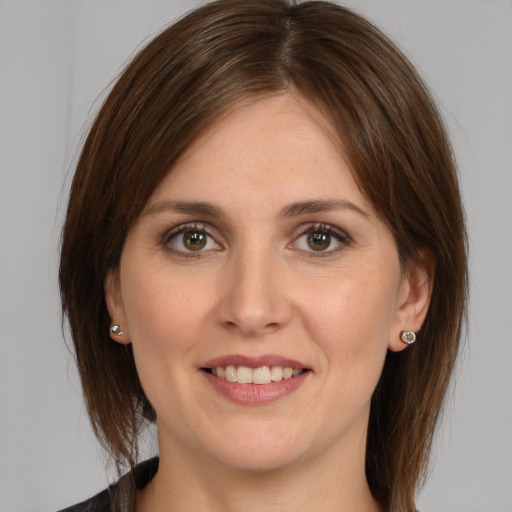 Joyful white young-adult female with medium  brown hair and brown eyes