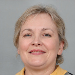 Joyful white adult female with medium  brown hair and blue eyes