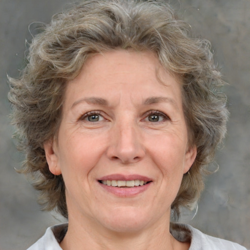 Joyful white middle-aged female with medium  brown hair and brown eyes