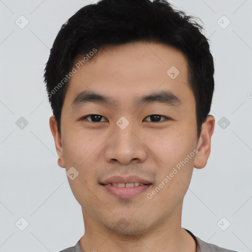 Joyful asian young-adult male with short  black hair and brown eyes