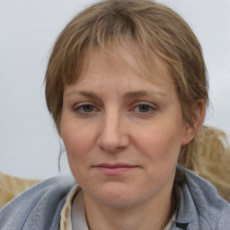 Joyful white adult female with medium  brown hair and blue eyes