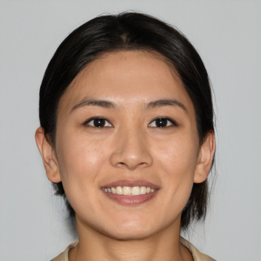 Joyful white young-adult female with medium  brown hair and brown eyes