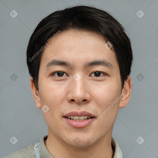 Joyful asian young-adult male with short  brown hair and brown eyes