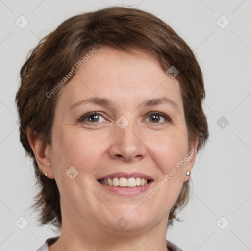 Joyful white adult female with medium  brown hair and grey eyes