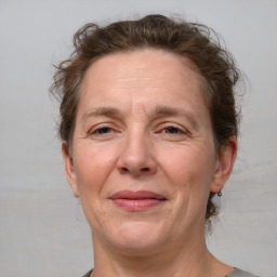 Joyful white middle-aged female with short  brown hair and brown eyes