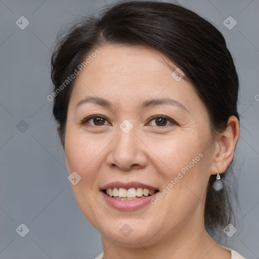 Joyful white adult female with medium  brown hair and brown eyes