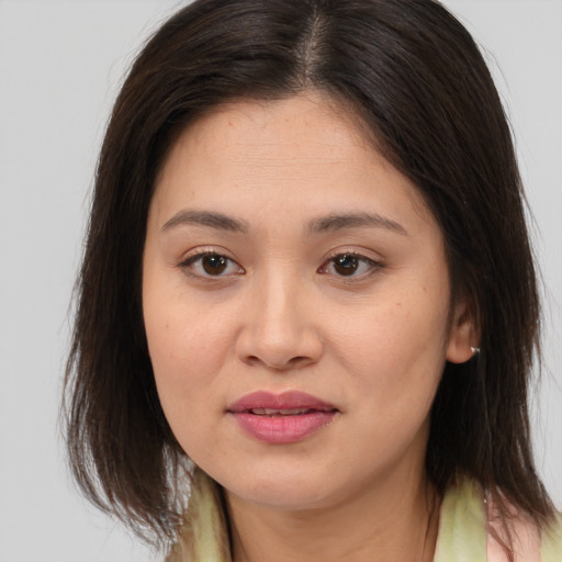 Joyful white young-adult female with medium  brown hair and brown eyes