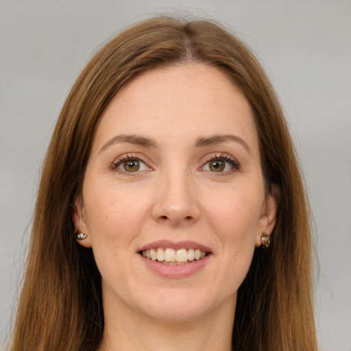 Joyful white young-adult female with long  brown hair and green eyes