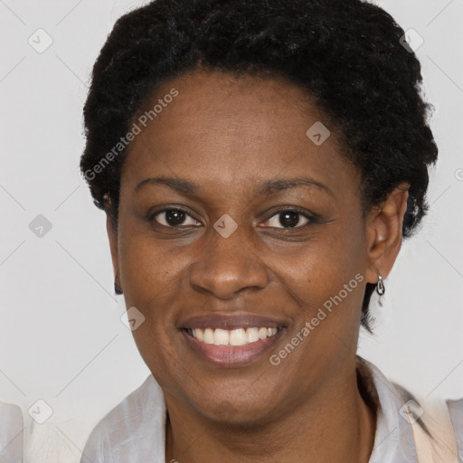 Joyful black adult female with short  brown hair and brown eyes