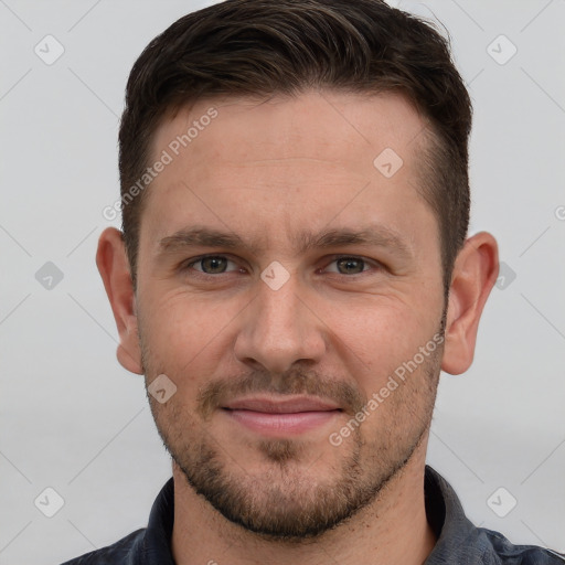 Joyful white young-adult male with short  brown hair and grey eyes