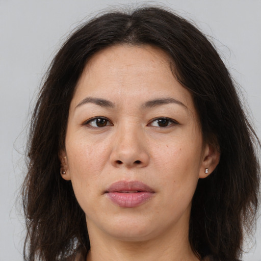 Joyful asian adult female with long  brown hair and brown eyes