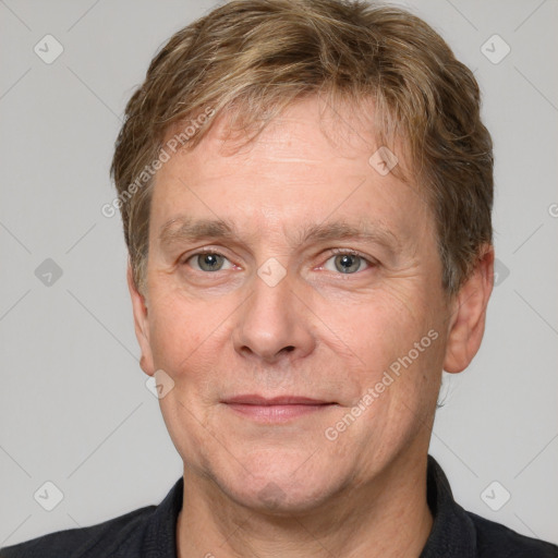 Joyful white adult male with short  brown hair and grey eyes