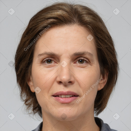 Joyful white adult female with medium  brown hair and brown eyes