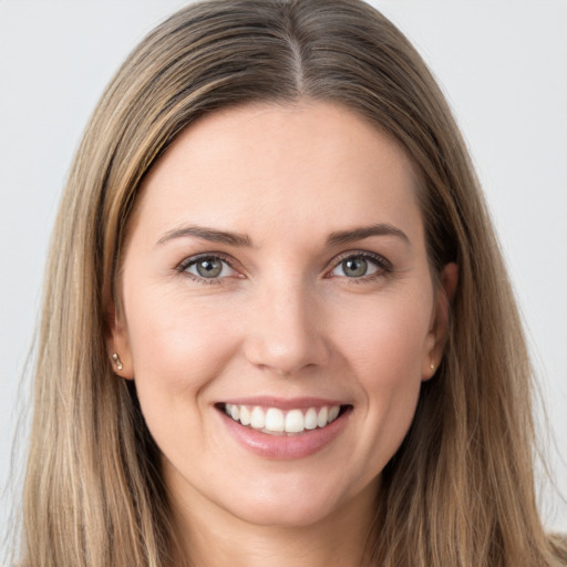 Joyful white young-adult female with long  brown hair and grey eyes