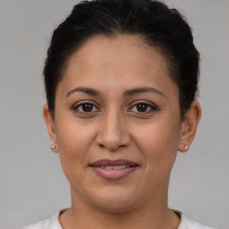 Joyful white young-adult female with short  brown hair and brown eyes