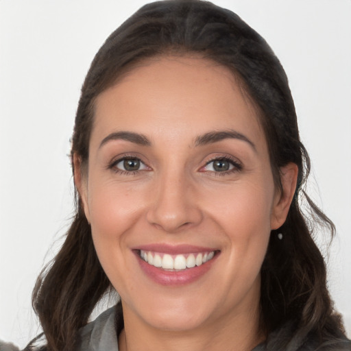 Joyful white young-adult female with long  brown hair and brown eyes